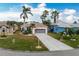 Single-story home with a two-car garage and landscaped yard at 10214 Windsong Rd, Punta Gorda, FL 33955