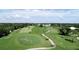 Aerial view of a lush green golf course at 10214 Windsong Rd, Punta Gorda, FL 33955
