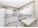 White kitchen with ample counter space and appliances at 10214 Windsong Rd, Punta Gorda, FL 33955