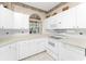 White kitchen with ample cabinet space and appliances at 10214 Windsong Rd, Punta Gorda, FL 33955