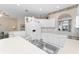 White kitchen with an island and stainless steel sink at 10214 Windsong Rd, Punta Gorda, FL 33955