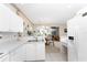 Open concept kitchen and dining area with white cabinets at 10214 Windsong Rd, Punta Gorda, FL 33955