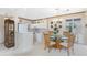 Open concept kitchen and dining area with white cabinets and breakfast bar at 10214 Windsong Rd, Punta Gorda, FL 33955