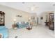 Spacious living room with light teal sofa and recliner at 10214 Windsong Rd, Punta Gorda, FL 33955