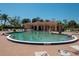 Kidney shaped community pool with plenty of lounge chairs at 10214 Windsong Rd, Punta Gorda, FL 33955