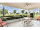Enjoy relaxing views from this screened porch, featuring a table and chairs at 10214 Windsong Rd, Punta Gorda, FL 33955
