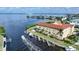 Aerial view of a waterfront property with a boat and dock at 115 Breakers Ct # 111, Punta Gorda, FL 33950
