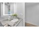 Bathroom with granite countertop, updated sink, and illuminated mirror at 115 Breakers Ct # 111, Punta Gorda, FL 33950