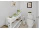 Powder room with toilet and storage shelf at 115 Breakers Ct # 111, Punta Gorda, FL 33950