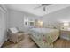 Spacious bedroom with light green bedding and ceiling fan at 115 Breakers Ct # 111, Punta Gorda, FL 33950