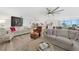 Open living space with hardwood floors, seating area and kitchen view at 115 Breakers Ct # 111, Punta Gorda, FL 33950