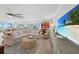 Living room with hardwood floors, sectional sofa and large TV at 115 Breakers Ct # 111, Punta Gorda, FL 33950