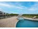 Relaxing pool and spa with patio furniture and a waterfront view at 115 Breakers Ct # 111, Punta Gorda, FL 33950