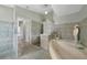 Bathroom with soaking tub and access to hallway at 1320 Appian Dr, Punta Gorda, FL 33950