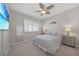 Bedroom with a TV, large windows and ceiling fan at 1320 Appian Dr, Punta Gorda, FL 33950