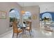 Bright dining room with glass table and wicker chairs, offering water views at 1320 Appian Dr, Punta Gorda, FL 33950