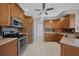 Modern kitchen with ample cabinetry, stainless steel appliances, and tile flooring at 1320 Appian Dr, Punta Gorda, FL 33950