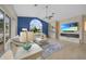 Living room boasts a fireplace, large TV, and calming blue accent wall at 1320 Appian Dr, Punta Gorda, FL 33950