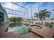 Large pool and spa with screened enclosure and canal view at 1320 Appian Dr, Punta Gorda, FL 33950