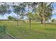 Spacious backyard with grassy area and trees at 13366 Bronze Ave, Port Charlotte, FL 33981