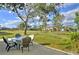 View of a spacious backyard with grassy area and mature trees at 13366 Bronze Ave, Port Charlotte, FL 33981