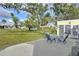 Relaxing patio furniture on a spacious concrete patio, overlooking a large backyard at 13366 Bronze Ave, Port Charlotte, FL 33981