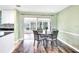 Dining area with sliding doors leading to the sunroom and kitchen access at 13366 Bronze Ave, Port Charlotte, FL 33981