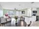 Open concept living and dining area with wood-look floors and modern kitchen at 13366 Bronze Ave, Port Charlotte, FL 33981