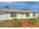 Cute yellow house with well-manicured landscaping and a spacious front yard at 13366 Bronze Ave, Port Charlotte, FL 33981