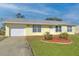 Single-story home with attached garage and nicely landscaped front yard at 13366 Bronze Ave, Port Charlotte, FL 33981