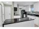 Updated kitchen featuring white cabinets, granite countertops, and black appliances at 13366 Bronze Ave, Port Charlotte, FL 33981