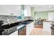 Updated kitchen with white cabinets, granite countertops, and tile backsplash at 13366 Bronze Ave, Port Charlotte, FL 33981
