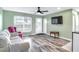 Living room features wood-look floors and a view into the kitchen and dining area at 13366 Bronze Ave, Port Charlotte, FL 33981