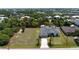 Aerial view showing a single-Gathering home with a large backyard and surrounding houses at 15105 Aldama Cir, Port Charlotte, FL 33981