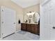 Double vanity bathroom with beige walls and hexagon tile floor at 15105 Aldama Cir, Port Charlotte, FL 33981