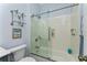 Clean bathroom with a walk-in shower and a blue vanity at 15105 Aldama Cir, Port Charlotte, FL 33981