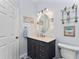 Updated bathroom with a dark vanity and a large mirror at 15105 Aldama Cir, Port Charlotte, FL 33981