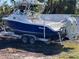 Triton 2690 fishing boat with twin Evinrude E-TEC engines on a trailer at 15105 Aldama Cir, Port Charlotte, FL 33981