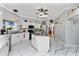 Modern kitchen with white cabinets, granite island, and marble-look tile floors at 15105 Aldama Cir, Port Charlotte, FL 33981