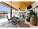 Covered lanai with pool view, outdoor seating, and mini-fridge at 15105 Aldama Cir, Port Charlotte, FL 33981