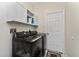 Bright laundry room, featuring washer, dryer, and overhead cabinets at 15105 Aldama Cir, Port Charlotte, FL 33981
