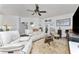 Relaxing living room with light leather furniture, hardwood floors, and large windows at 15105 Aldama Cir, Port Charlotte, FL 33981
