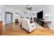 Relaxing living room with hardwood floors and large TV at 15105 Aldama Cir, Port Charlotte, FL 33981