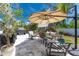 Spacious patio with seating area, umbrella, and hot tub at 15105 Aldama Cir, Port Charlotte, FL 33981