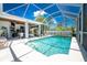 Enjoy this refreshing pool with a screened enclosure and patio furniture at 15105 Aldama Cir, Port Charlotte, FL 33981