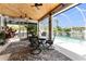 Relaxing screened lanai with pool view, table and chairs, wood ceiling at 15105 Aldama Cir, Port Charlotte, FL 33981