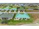 Aerial image showing multiple homes in a community with green roofs and a golf course at 1551 Atares Dr # 112, Punta Gorda, FL 33950