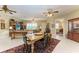Open dining area with a wooden table, access to the kitchen, and a view of the Primary bedroom at 1551 Atares Dr # 112, Punta Gorda, FL 33950