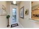 Bright and spacious entryway with a glass door and kitchen peek at 1551 Atares Dr # 112, Punta Gorda, FL 33950