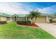 Exterior view of a charming house with a green metal roof, two-car garage, and manicured lawn at 1551 Atares Dr # 112, Punta Gorda, FL 33950